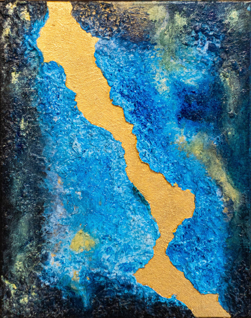 Abstract artwork with blue and gold colors on a textured background