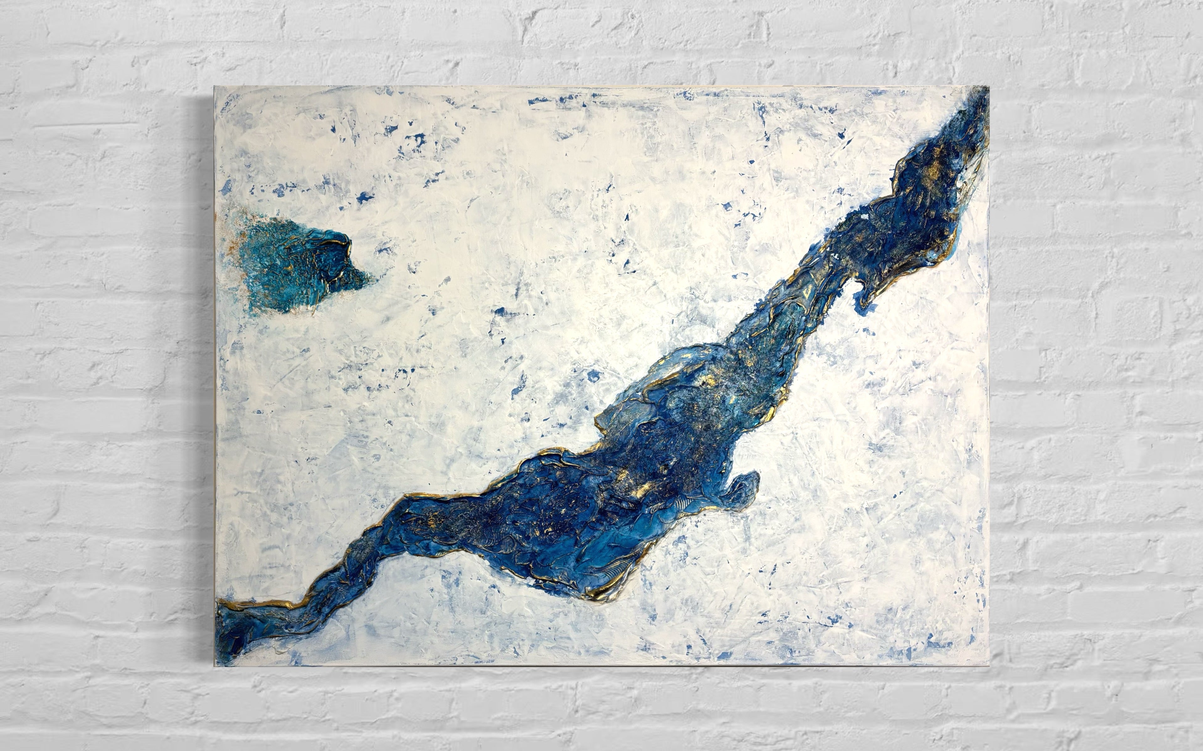 Abstract art piece with blue and gold patterns on a textured white background