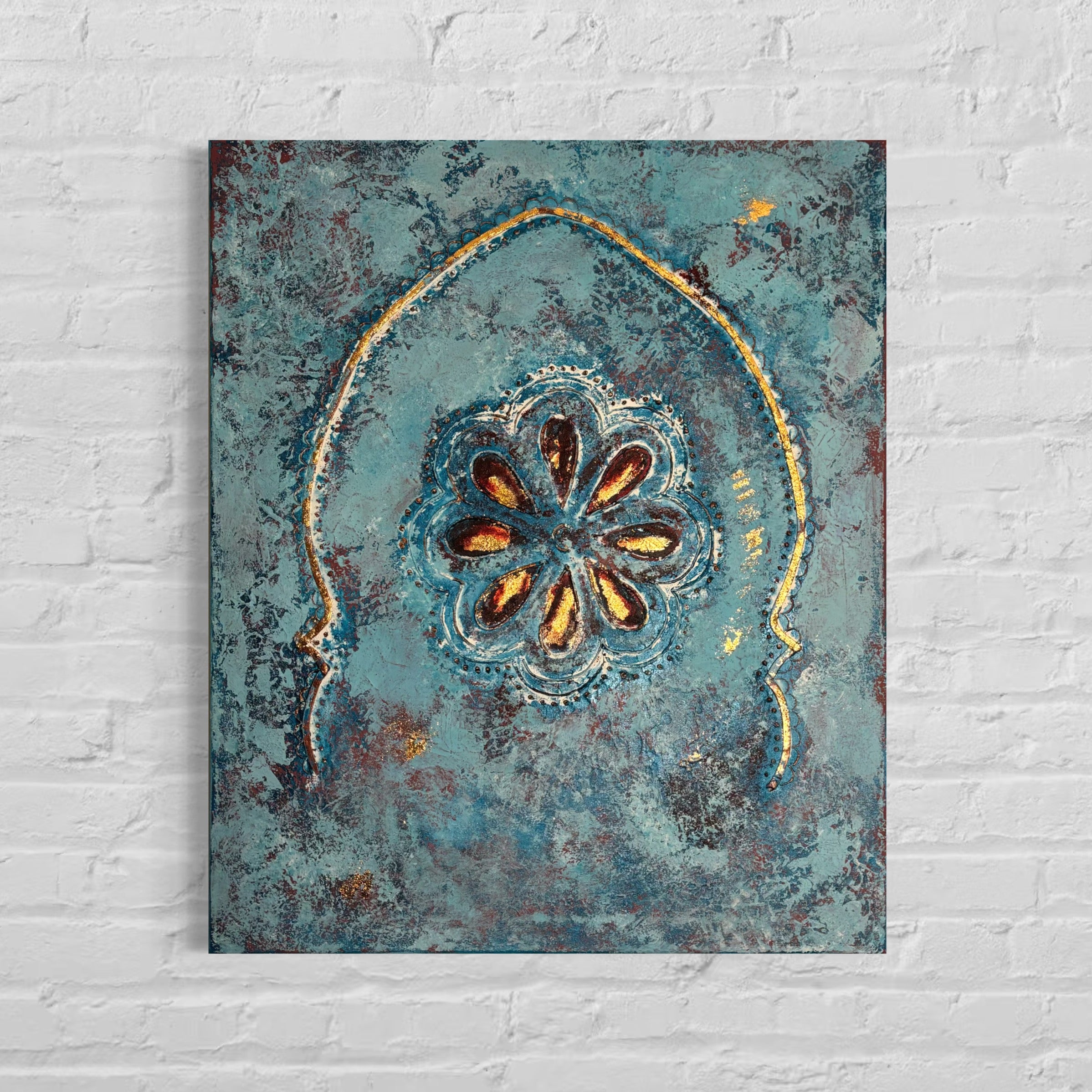 Decorative wall art with a floral design on a textured blue background, mounted on a white brick wall.