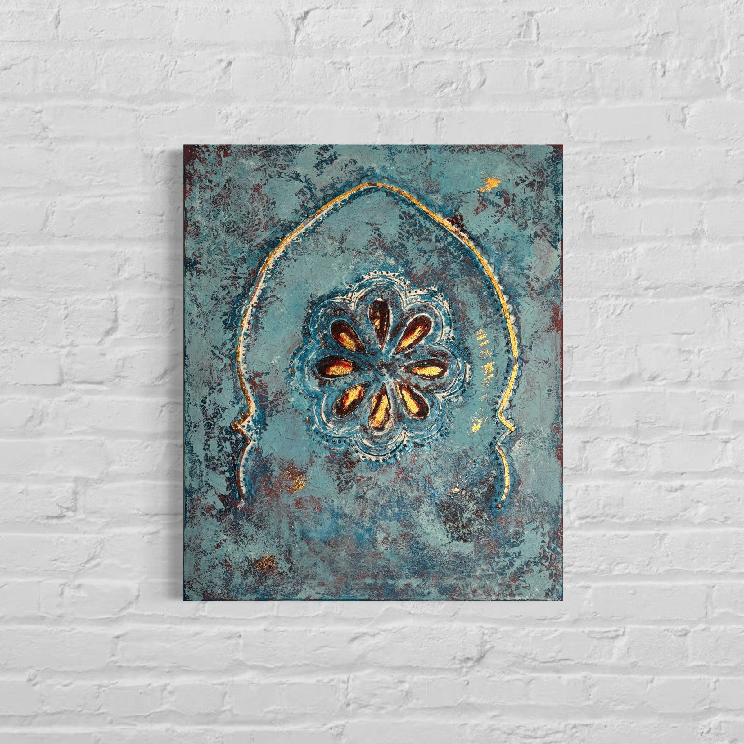 Decorative wall art with a floral design on a textured blue background, mounted on a white brick wall.